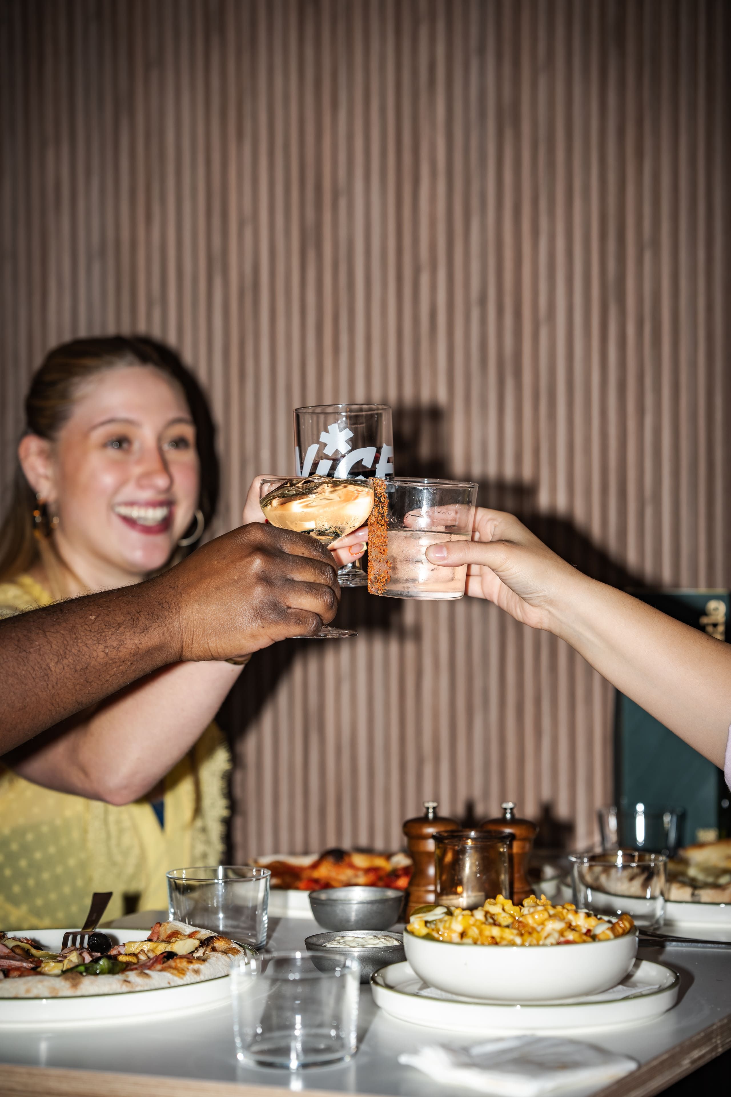 People cheers their drinks at Trickle